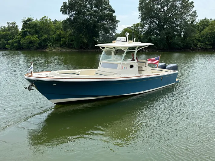 Heron Yacht Photos Pics 2017 Hunt Yachts 32 Center Console boat on calm water, American flag displayed.