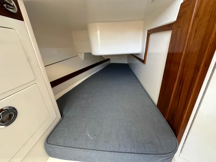 Heron Yacht Photos Pics 2017 Hunt Yachts 32 Center Console cabin interior with cushioned berth and wooden accents.