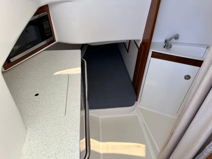 Heron Yacht Photos Pics 2017 Hunt Yachts 32 Center Console interior with kitchenette, sink, and sleeping area.