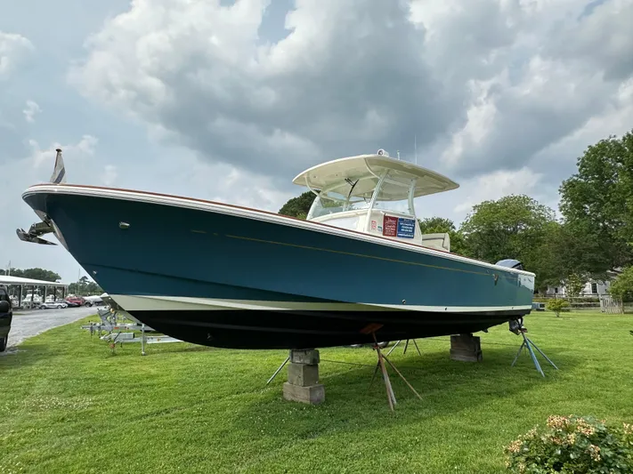 Heron Yacht Photos Pics 2017 Hunt Yachts 32 Center Console on grass, under cloudy sky.
