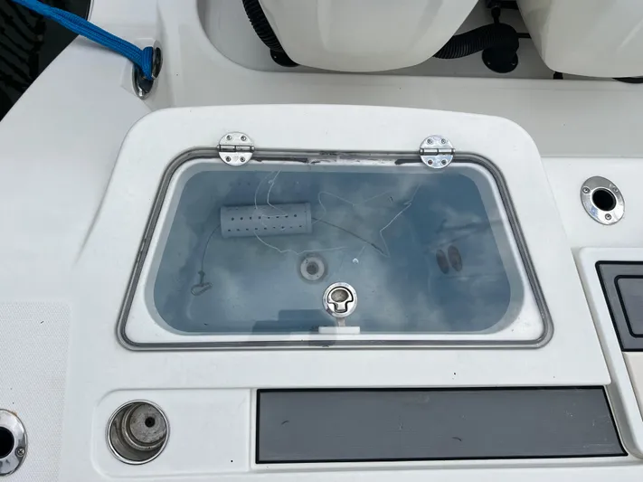 The Perfect Predator Yacht Photos Pics Livewell on 2017 Mako 414 CC Bluewater Family Edition boat, featuring a clear lid and fittings.