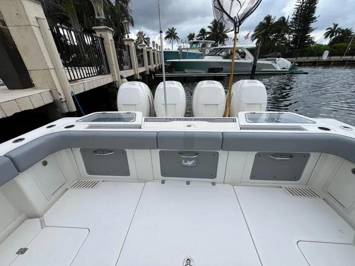 The Perfect Predator Yacht Photos Pics 2017 Mako 414 CC Bluewater boat interior with four engines, docked by palm trees.