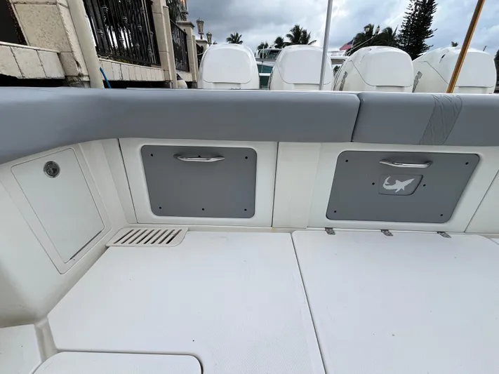The Perfect Predator Yacht Photos Pics 2017 Mako 414 CC Bluewater boat interior with storage compartments and cushioned seating.