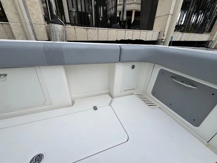 The Perfect Predator Yacht Photos Pics Interior view of 2017 Mako 414 CC Bluewater Family Edition boat, featuring sleek seating and storage.