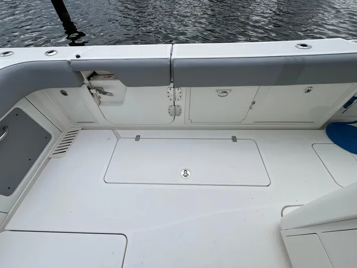 The Perfect Predator Yacht Photos Pics 2017 Mako 414 CC Bluewater boat deck with storage compartments and seating.