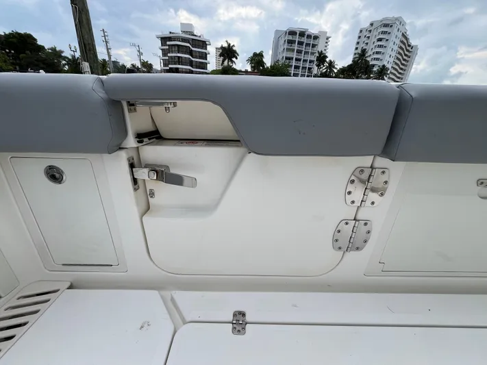 The Perfect Predator Yacht Photos Pics 2017 Mako 414 CC Bluewater boat interior with gray seating and storage compartments.