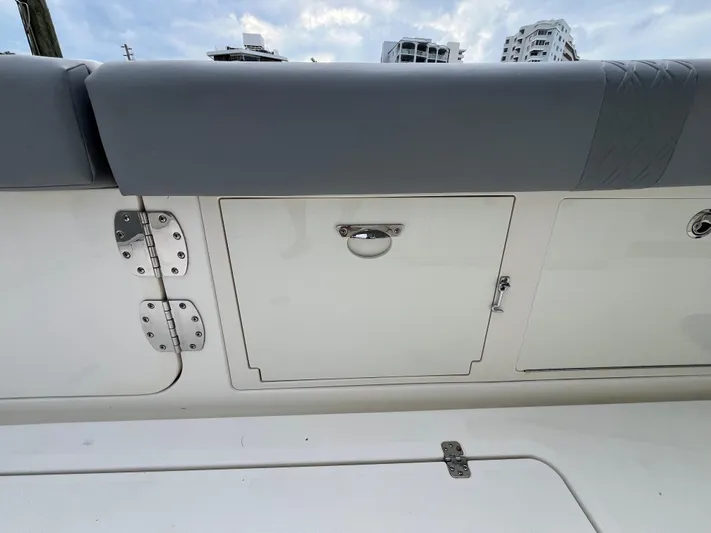 The Perfect Predator Yacht Photos Pics 2017 Mako 414 CC Bluewater Family Edition boat storage compartment with cushioned seating.