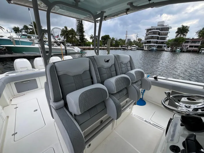 The Perfect Predator Yacht Photos Pics 2017 Mako 414 CC Bluewater boat interior with luxurious seating and steering wheel.