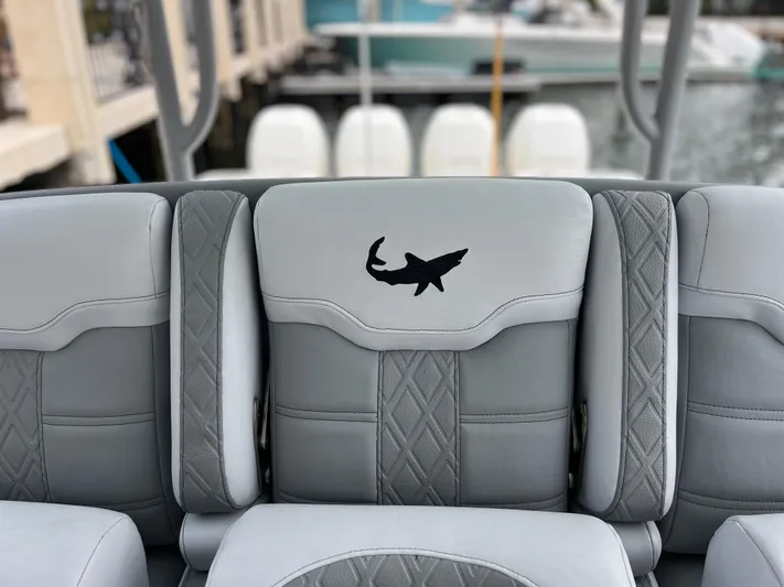 The Perfect Predator Yacht Photos Pics Gray boat seating with shark logo on a 2017 Mako 414 CC Bluewater Family Edition.
