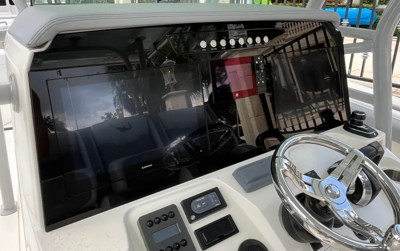 The Perfect Predator Yacht Photos Pics Control panel of 2017 Mako 414 CC Bluewater Family Edition boat with steering wheel.