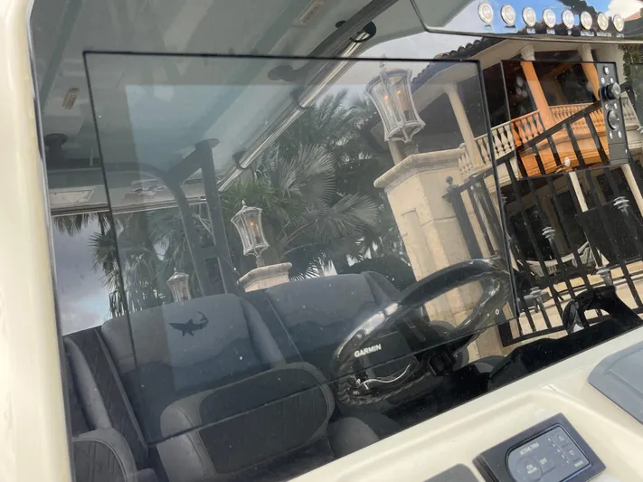 The Perfect Predator Yacht Photos Pics 2017 Mako 414 CC Bluewater boat interior with Garmin steering, near a luxurious house.