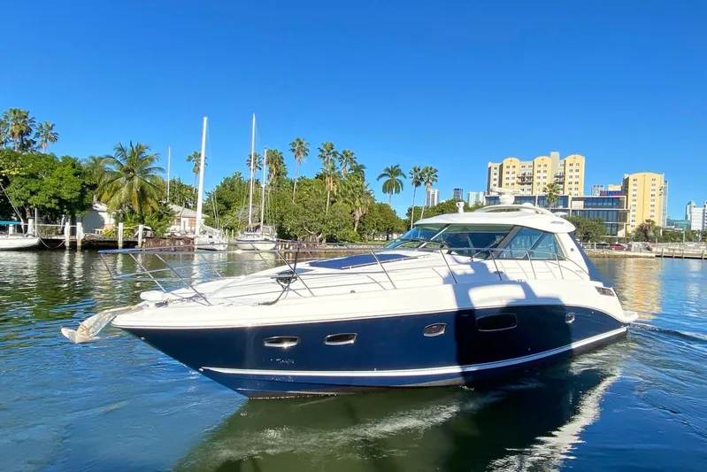 Beach House Yacht Photos Pics 2010 Sea Ray 450 Sundancer yacht cruising in a scenic marina setting.