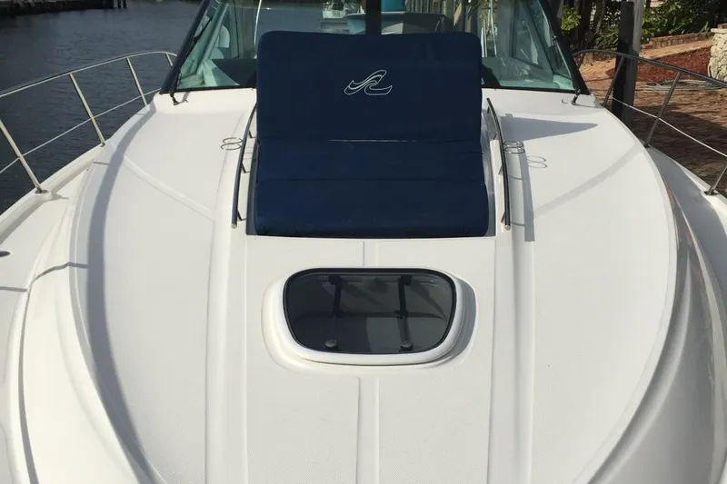 Beach House Yacht Photos Pics 2010 Sea Ray 450 Sundancer yacht deck with blue sunbed and hatch.