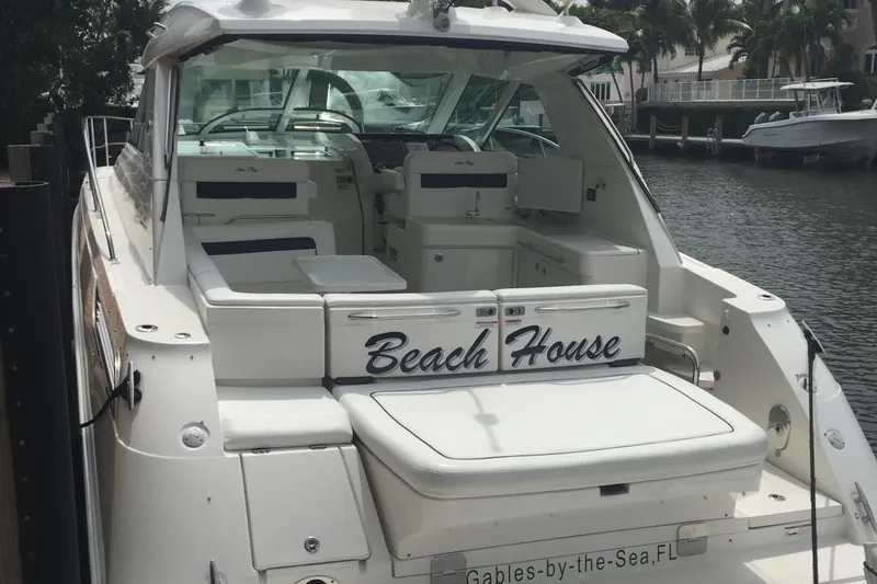 Beach House Yacht Photos Pics 2010 Sea Ray 450 Sundancer yacht named "Beach House" docked by the water.