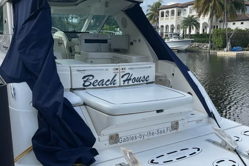 Beach House Yacht Photos Pics 2010 Sea Ray 450 Sundancer yacht docked, featuring "Beach House" name, luxurious interior.