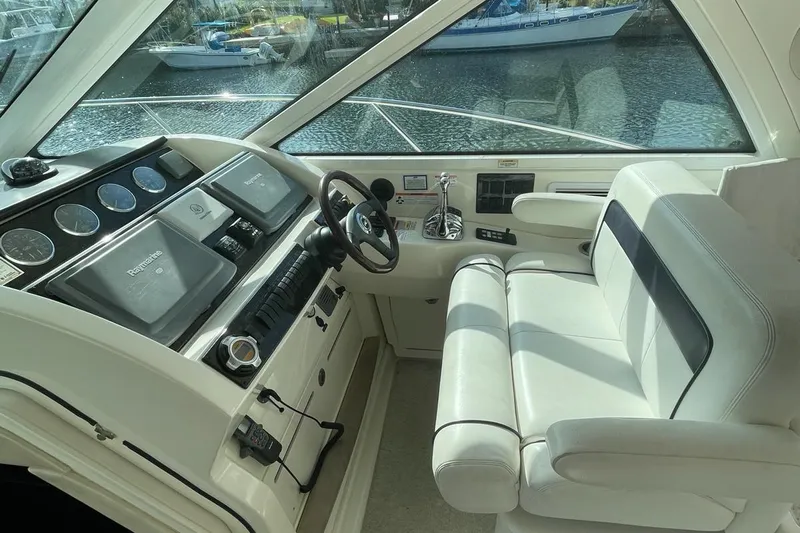 Beach House Yacht Photos Pics Helm of 2010 Sea Ray 450 Sundancer with modern controls and comfortable seating.