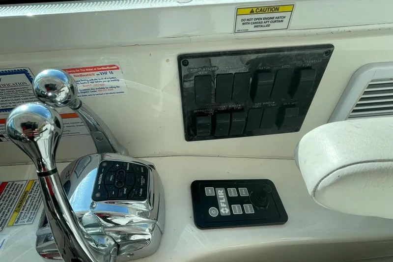 Beach House Yacht Photos Pics Control panel of a 2010 Sea Ray 450 Sundancer boat with throttle and switches.