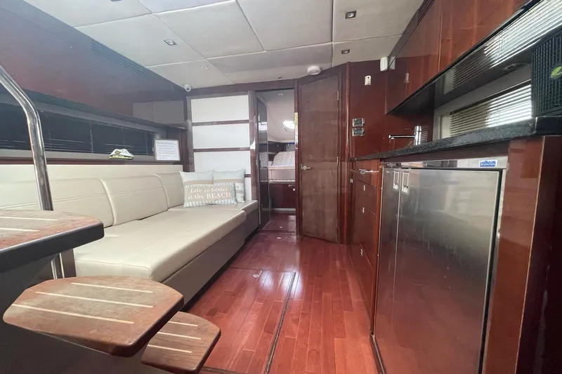 Beach House Yacht Photos Pics Luxurious interior of 2010 Sea Ray 450 Sundancer yacht with modern kitchen and seating area.