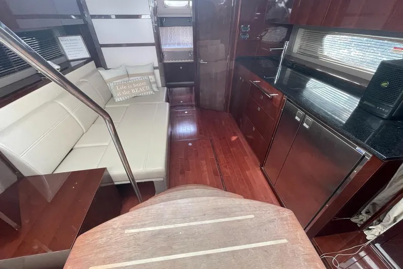 Beach House Yacht Photos Pics Luxurious interior of 2010 Sea Ray 450 Sundancer yacht with modern kitchen and cozy seating.