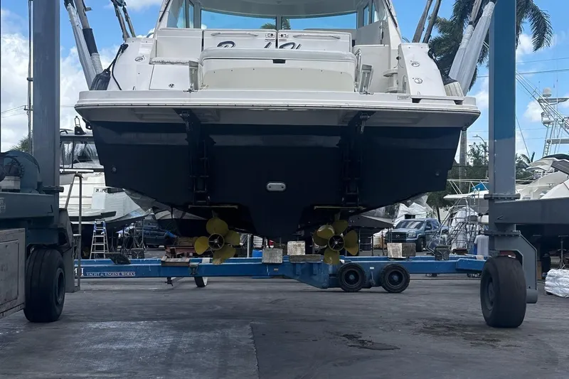 Beach House Yacht Photos Pics 2010 Sea Ray 450 Sundancer yacht on a lift in a marina setting.