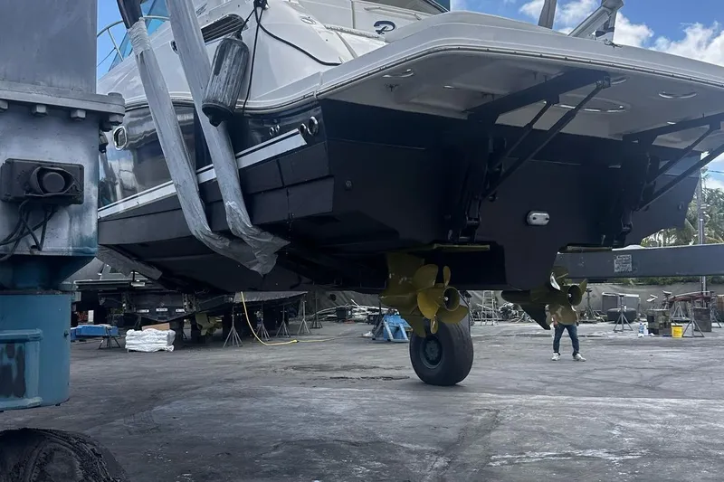 Beach House Yacht Photos Pics 2010 Sea Ray 450 Sundancer yacht in dry dock, showcasing propellers and hull.