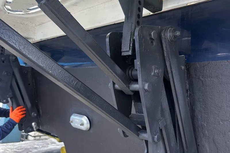 Beach House Yacht Photos Pics Close-up of 2010 Sea Ray 450 Sundancer boat's mechanical components with orange-gloved hand.