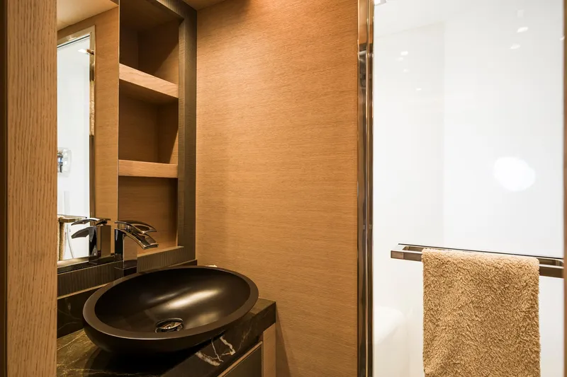 Crazy Diamond Yacht Photos Pics Modern bathroom in 2016 Monte Carlo Yachts MCY 70 with black sink and wooden shelves.