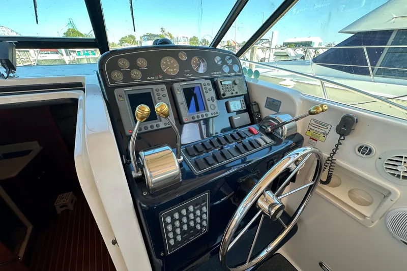  Yacht Photos Pics Control panel of a 2001 Tiara Yachts 3500 Open, featuring navigation instruments and steering wheel.