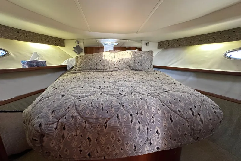  Yacht Photos Pics Cozy cabin interior of 2001 Tiara Yachts 3500 Open with patterned bedding.