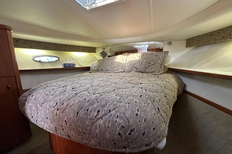  Yacht Photos Pics Luxurious cabin interior of 2001 Tiara Yachts 3500 Open with cozy bedding.