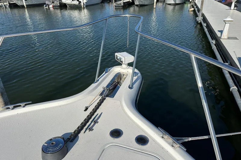  Yacht Photos Pics Bow of 2001 Tiara Yachts 3500 Open at marina, featuring anchor and railing.