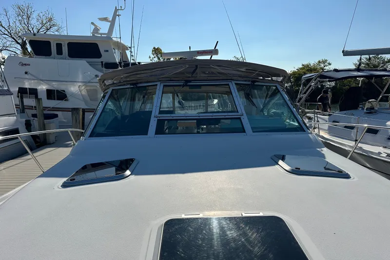  Yacht Photos Pics 2001 Tiara Yachts 3500 Open docked, showcasing sleek design and spacious deck.