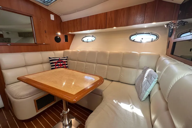  Yacht Photos Pics 2001 Tiara Yachts 3500 Open interior with plush seating and wooden table.