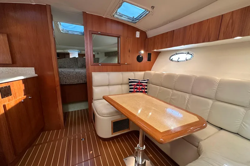  Yacht Photos Pics Interior of 2001 Tiara Yachts 3500 Open, featuring cozy seating and wooden accents.