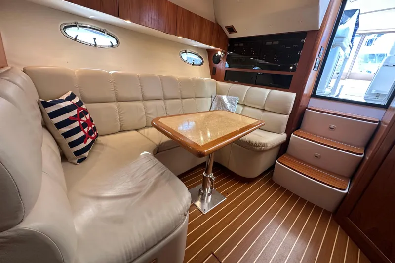  Yacht Photos Pics Interior of 2001 Tiara Yachts 3500 Open with plush seating and wooden accents.