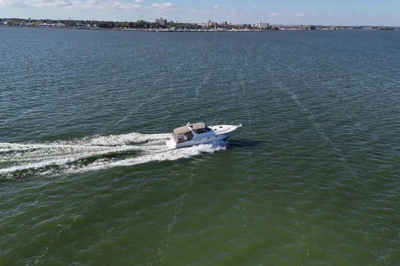  Yacht Photos Pics 2001 Tiara Yachts 3500 Open cruising on a vast, calm sea under a clear sky.