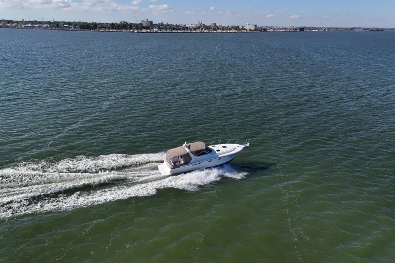  Yacht Photos Pics 2001 Tiara Yachts 3500 Open cruising on a vast, calm sea under a clear sky.