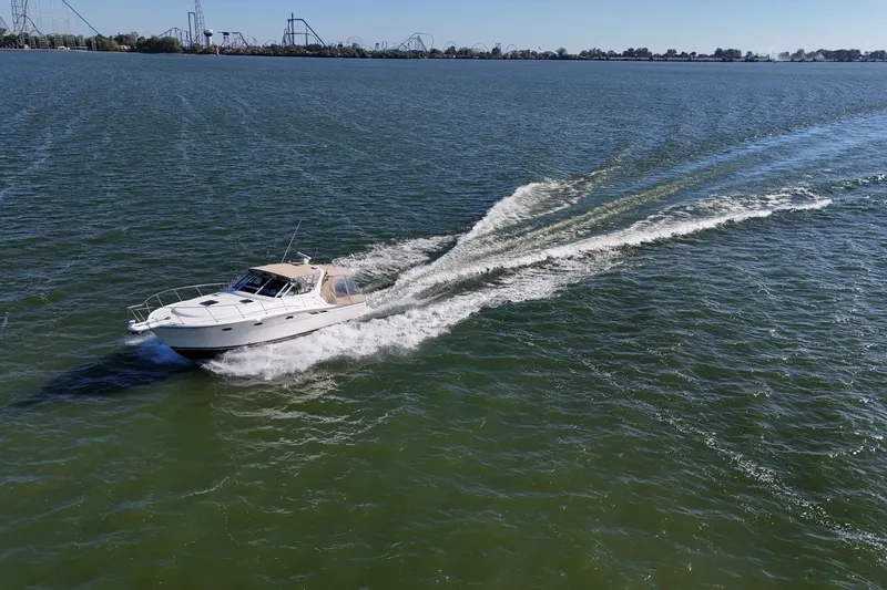  Yacht Photos Pics 2001 Tiara Yachts 3500 Open cruising on a sunny day with amusement park in background.