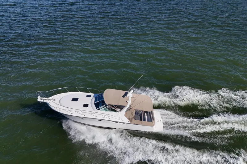  Yacht Photos Pics 2001 Tiara Yachts 3500 Open cruising on open water, creating a dynamic wake.