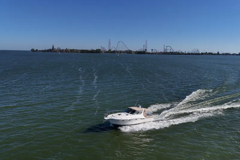  Yacht Photos Pics 2001 Tiara Yachts 3500 Open cruising on a lake with amusement park in background.