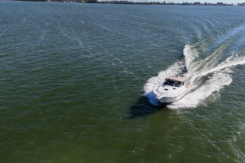  Yacht Photos Pics 2001 Tiara Yachts 3500 Open cruising on open water, creating a dynamic wake.