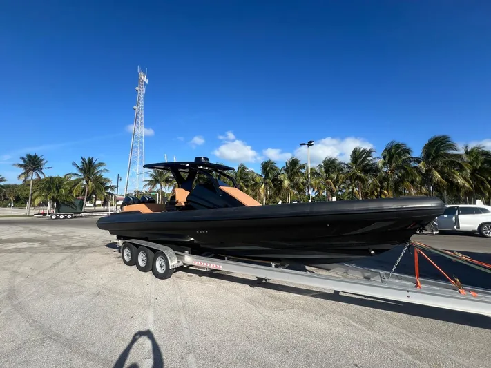 Novielli Yacht Photos Pics 2026 Novielli Veloche 349 boat on trailer, parked under clear blue sky with palm trees.
