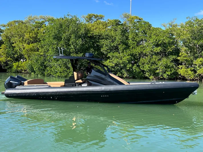 Novielli Yacht Photos Pics 2026 Novielli Veloche 349 boat on calm water, surrounded by lush greenery.
