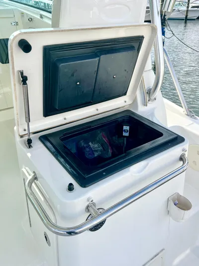  Yacht Photos Pics 2011 Boston Whaler 345 Conquest boat storage compartment with open lid.