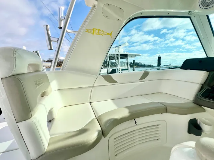  Yacht Photos Pics Interior view of 2011 Boston Whaler 345 Conquest boat with plush seating and window.
