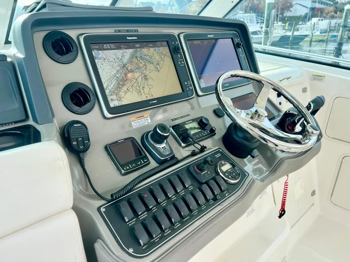  Yacht Photos Pics 2011 Boston Whaler 345 Conquest helm with navigation screens and controls.
