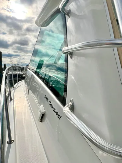  Yacht Photos Pics 2011 Boston Whaler 345 Conquest boat with sleek design and reflective windows.