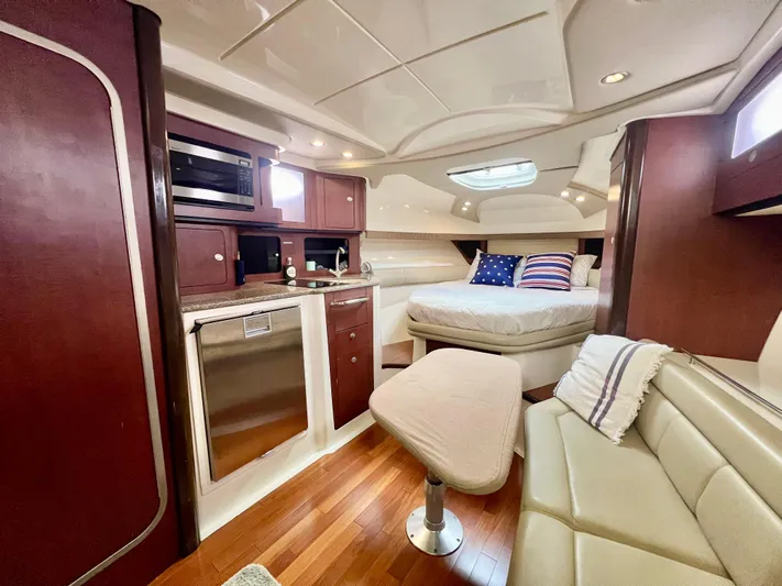  Yacht Photos Pics Luxurious interior of 2011 Boston Whaler 345 Conquest with bed, kitchenette, and seating area.