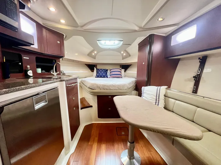  Yacht Photos Pics Luxurious interior of 2011 Boston Whaler 345 Conquest with modern amenities and cozy seating.