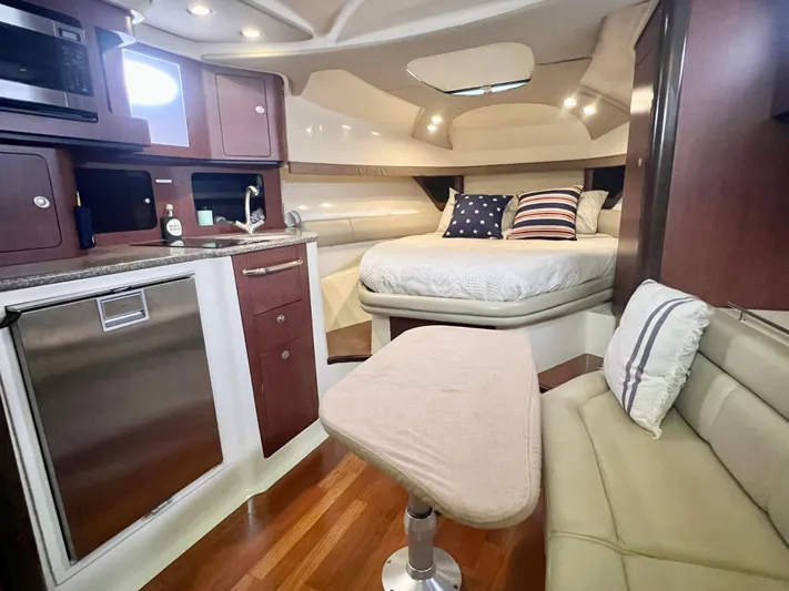  Yacht Photos Pics Luxurious interior of 2011 Boston Whaler 345 Conquest with kitchenette and cozy sleeping area.